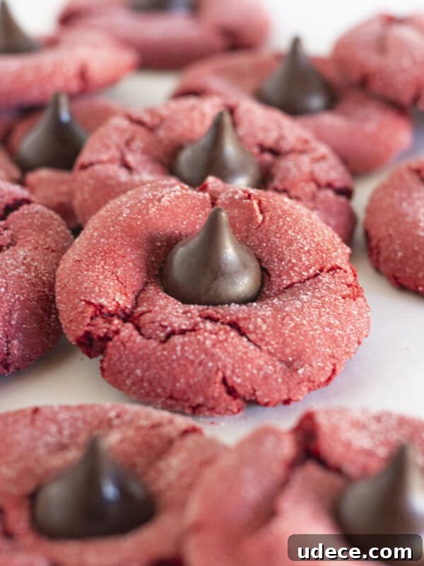 Chewy Chocolate Kiss Cookies Recipe: Classic Chocolate-Studded Cookies 7 Red Velvet Kiss Cookies on a white tray.