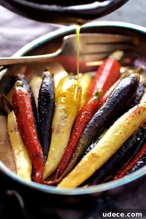 Photo of Curry Roasted Carrots with Honey Browned Butter with butter being drizzled over carrots.
