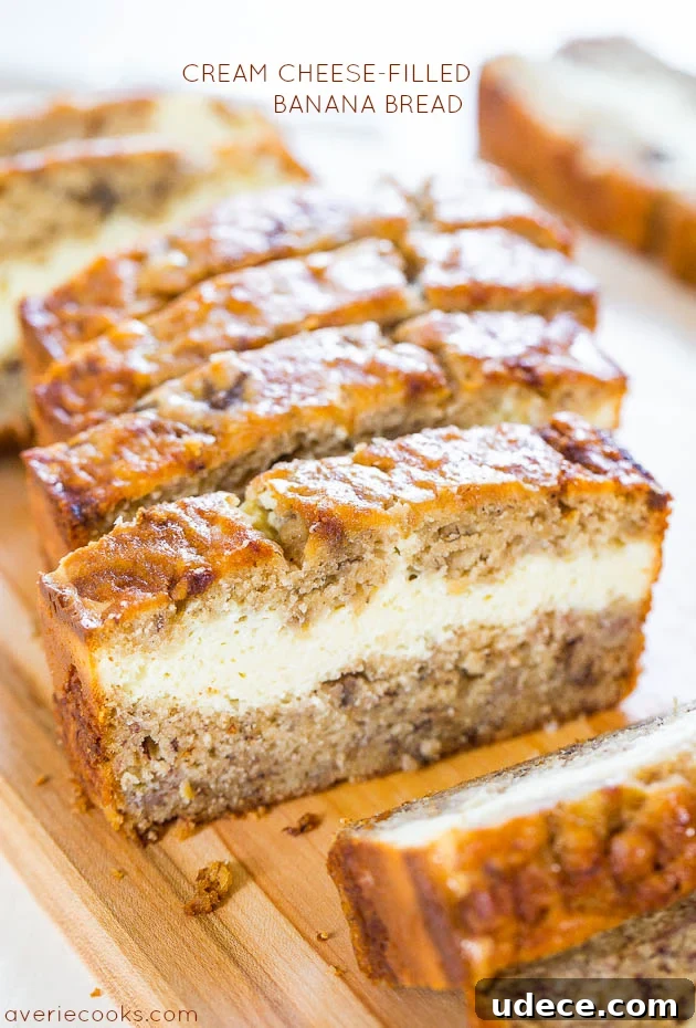 Cream Cheese-Filled Banana Bread sliced on a cutting board. 