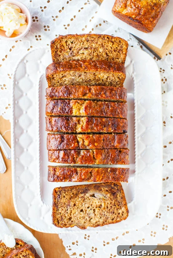 Six-Banana Banana Bread on a platter sliced into pieces. 