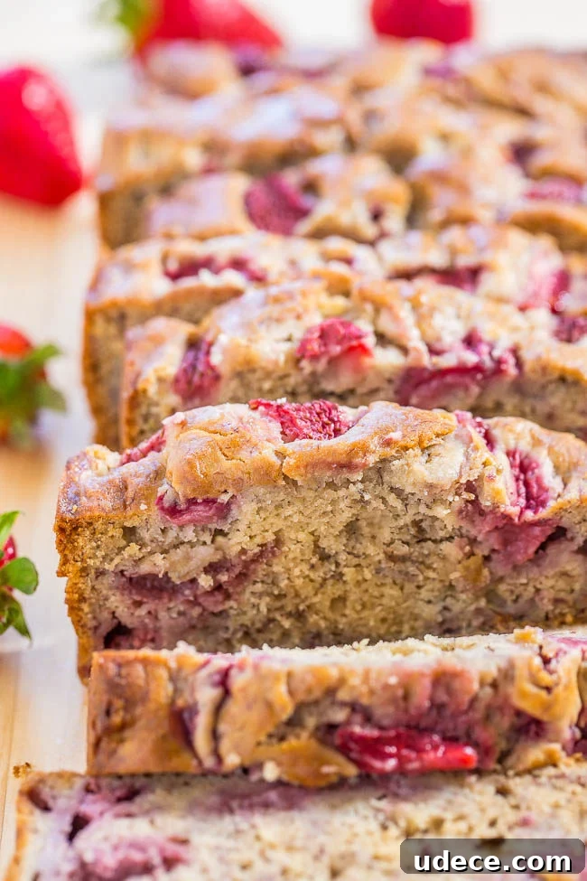 A sliced loaf of The Best Strawberry Banana Bread. 