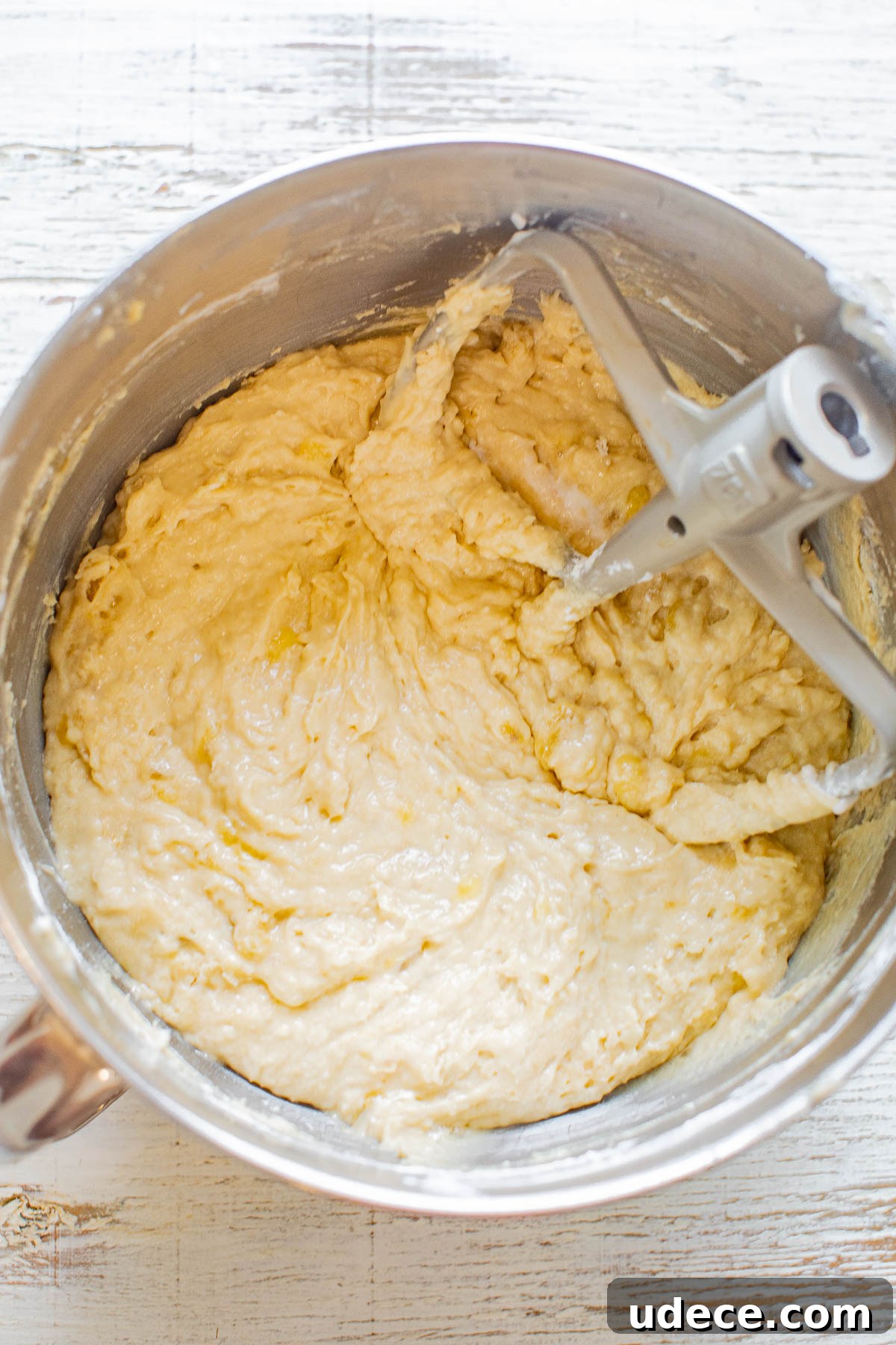 Banana cake batter in a stand mixer bowl. 