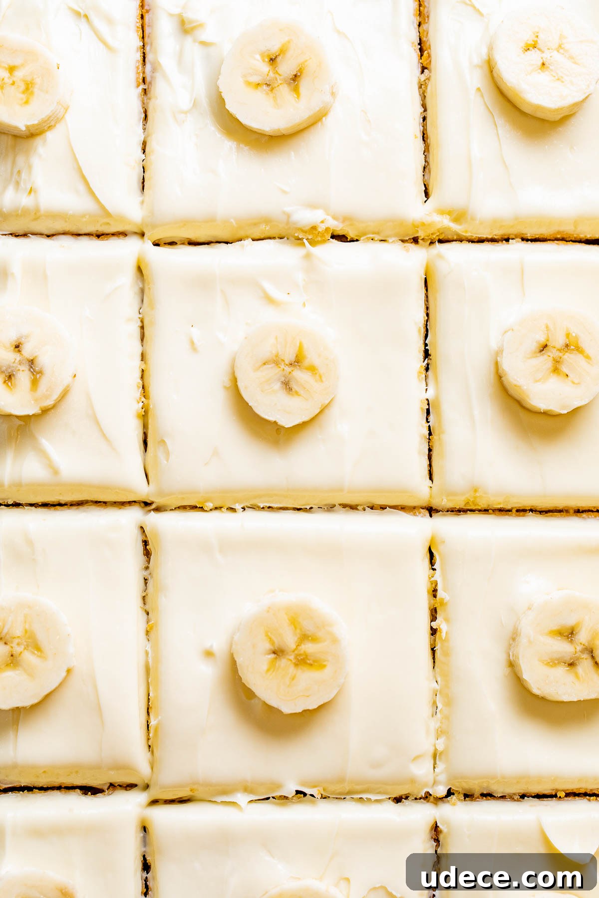 Best Banana Cake with Cream Cheese Frosting topped with banana coins. 