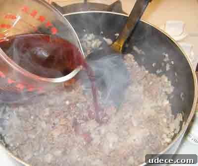 Spaghetti with Authentic Greek Meat Sauce (Makaronia me Kima) 5 Adding wine to the greek recipe makaronia me kima, greek spaghetti with meat sauce