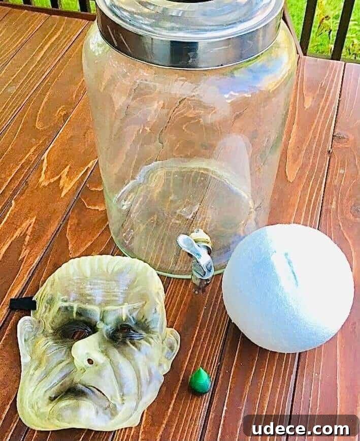 Creepy Halloween Jar Head Decoration Ideas and DIY Guide 4 Large jar, styrofoam ball, mask, and food coloring.