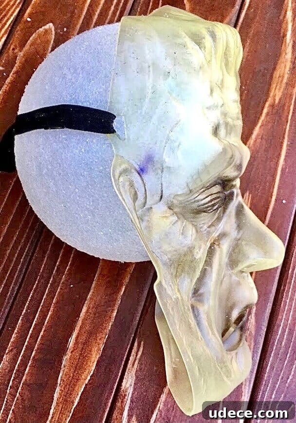Creepy Halloween Jar Head Decoration Ideas and DIY Guide 5 Attach mask to styrofoam ball.