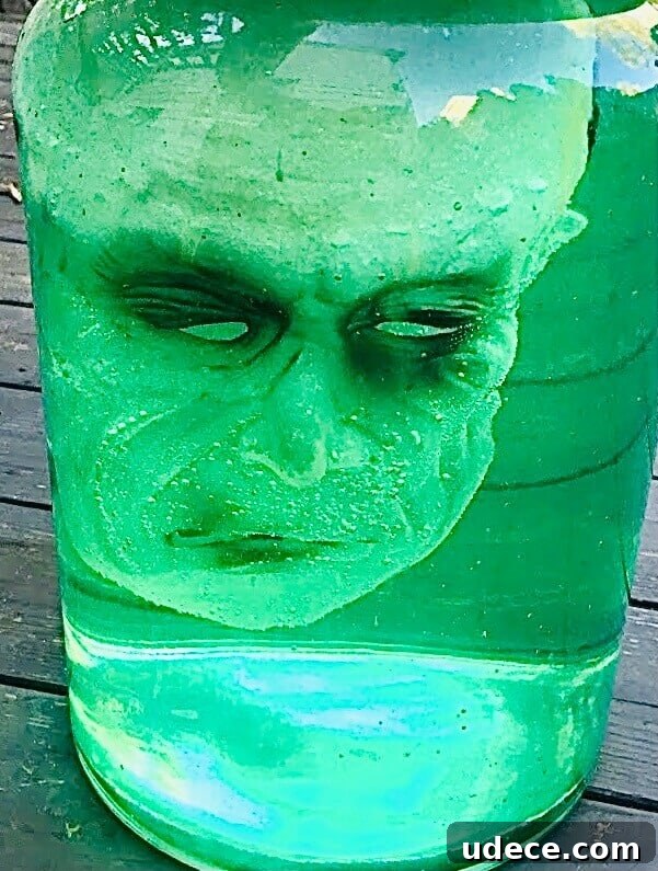Creepy Halloween Jar Head Decoration Ideas and DIY Guide 7 Finished head in a jar with water tinted with green food coloring.
