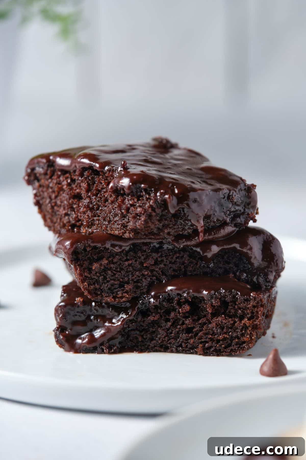 Moist Chocolate Fudge Cake Recipe You’ll Love 11 Stacked moist and fudgy chocolate fudgy cake on a plate.