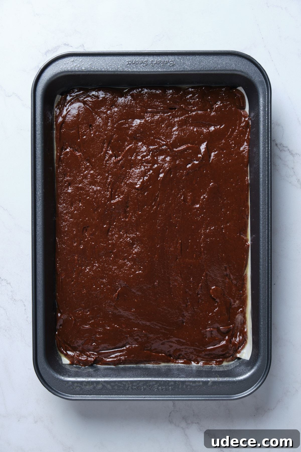 Moist Chocolate Fudge Cake Recipe You’ll Love 8 The chocolate fudge cake batter spread into a cake pan.