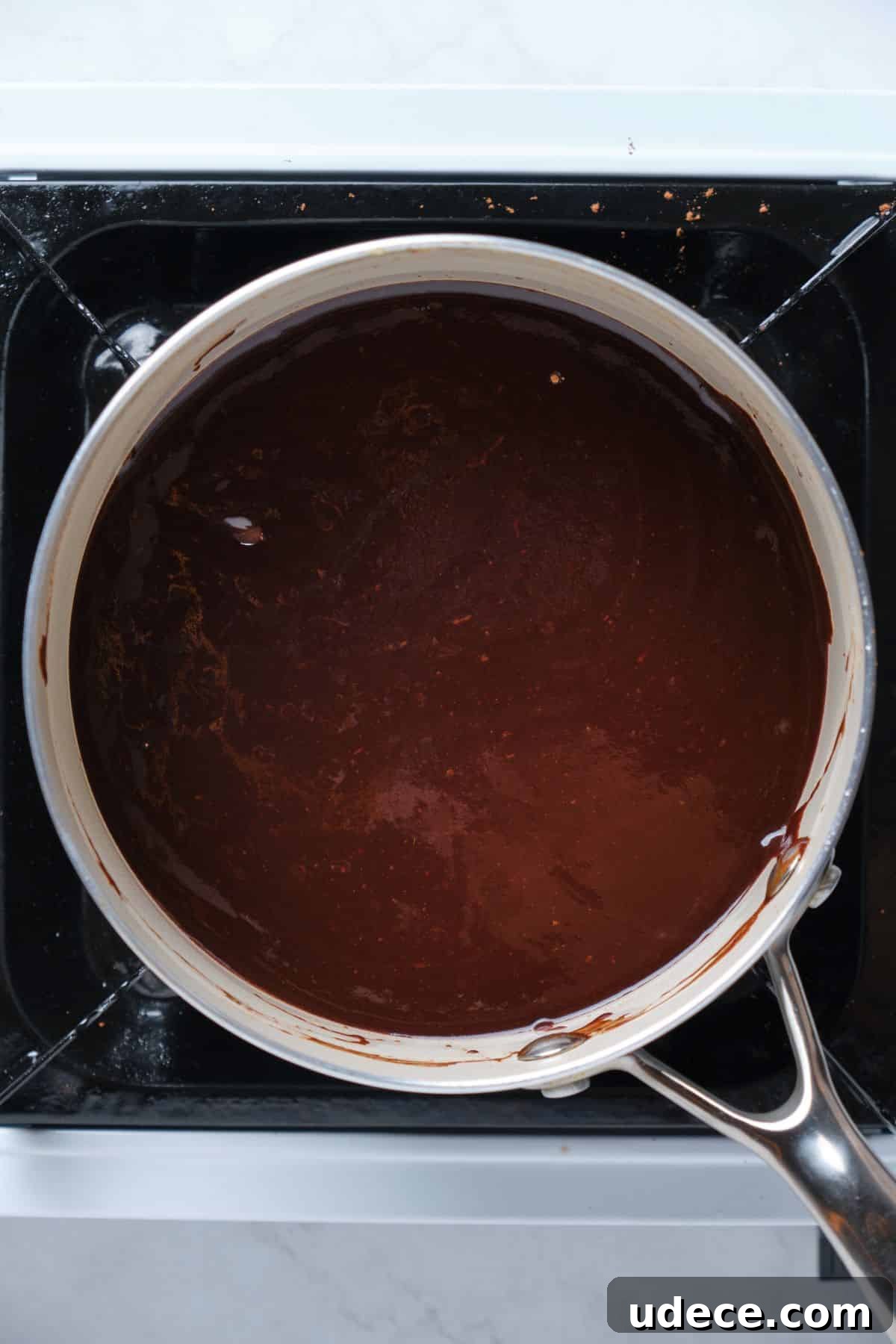 Moist Chocolate Fudge Cake Recipe You’ll Love 9 Chocolate fudge frosting in a saucepan.