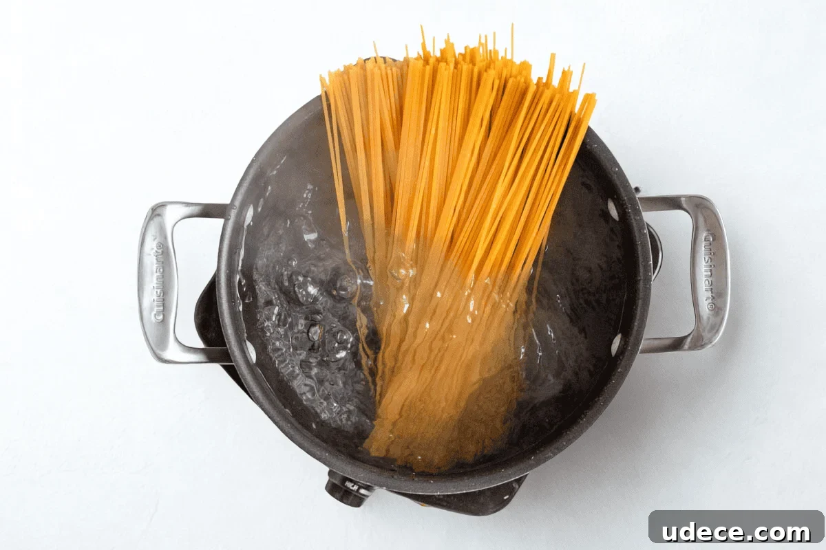 Garlic Butter Pasta with 4 Simple Ingredients 4 pasta going into boiling water.