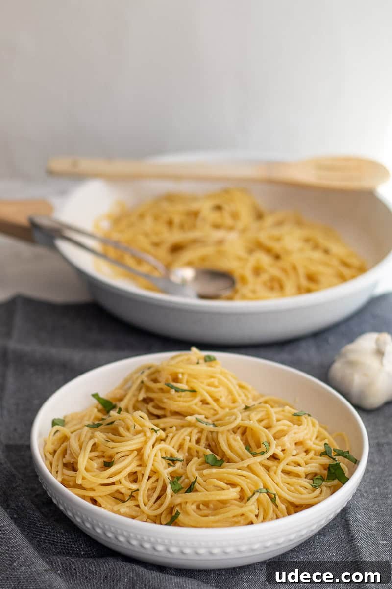 Garlic Butter Pasta with 4 Simple Ingredients 9 a big bowl of pasta with the pan in the background