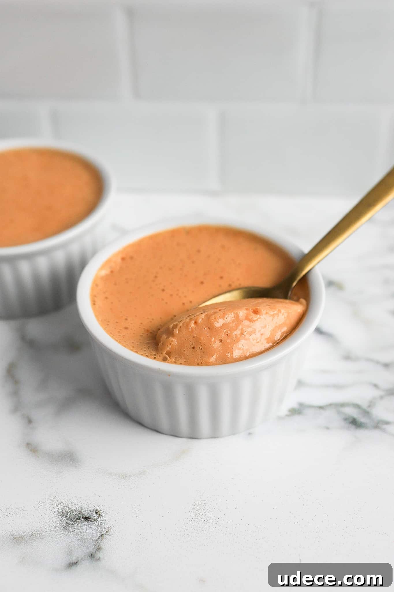 2-Ingredient Protein Pudding Without Greek Yogurt: Creamy Chocolate Recipe 2 close up shot of butterscotch protein pudding with gold spoon in white ramekins