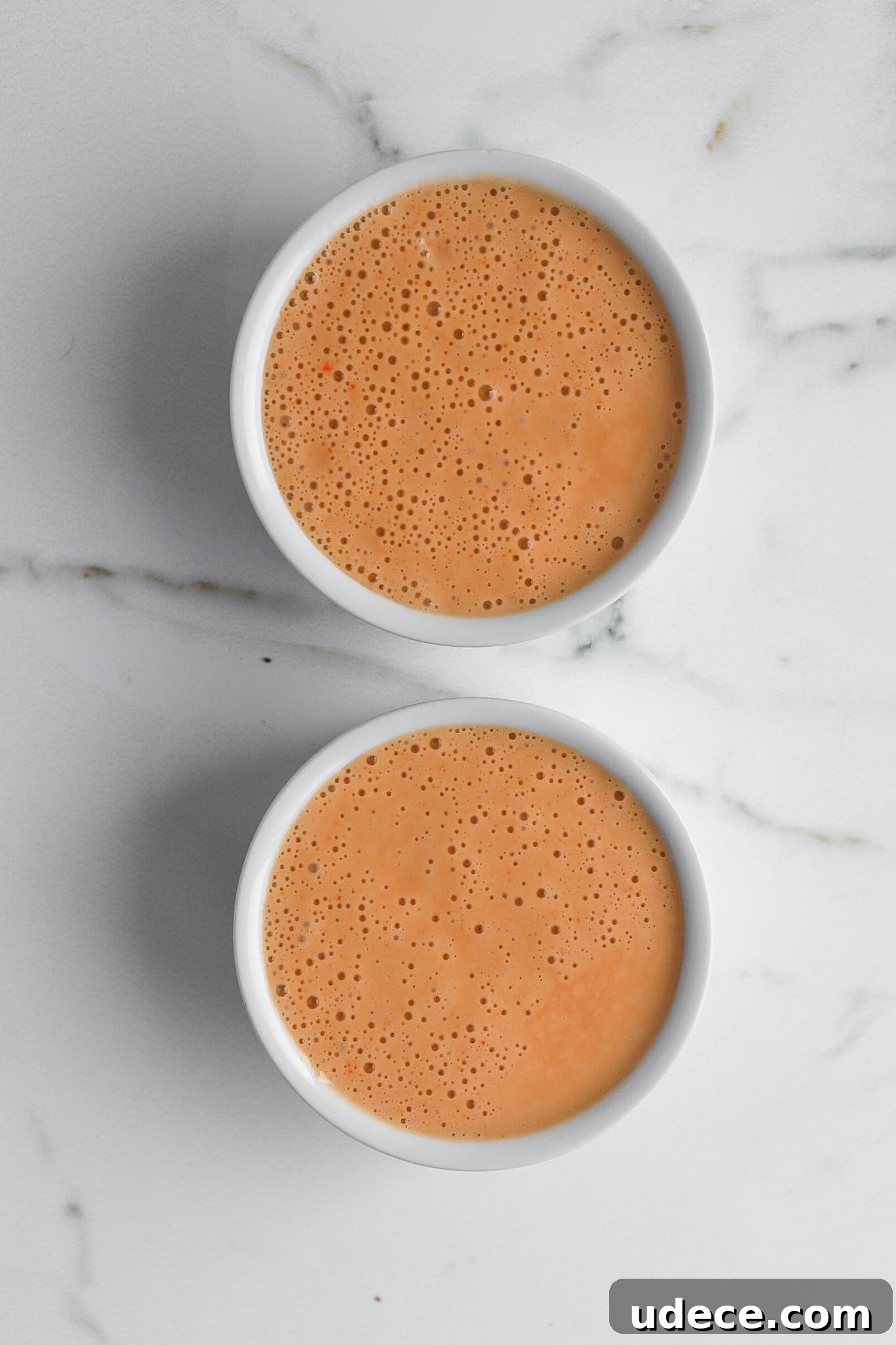 2-Ingredient Protein Pudding Without Greek Yogurt: Creamy Chocolate Recipe 5 top down view of two white ramekins of premier protein puddings