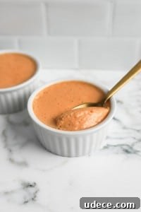 2-Ingredient Protein Pudding Without Greek Yogurt: Creamy Chocolate Recipe 7 close up shot of butterscotch protein pudding with gold spoon in white ramekins