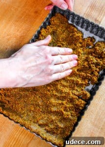 pressing out pistachio crust