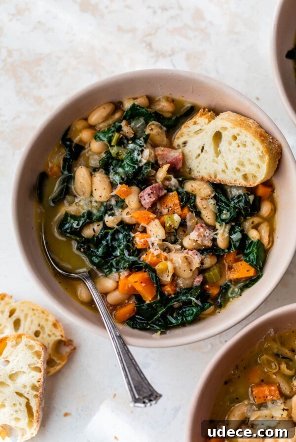 white bean soup in a bowl with a spoon and a slice of bread