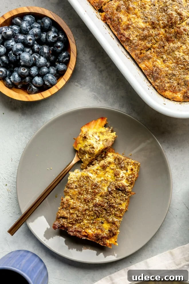 A slice of plantain breakfast casserole on a plate with a bite of it sitting on a fork.