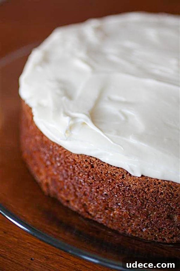 carrot cake with creamy cream cheese frosting on a glass plate