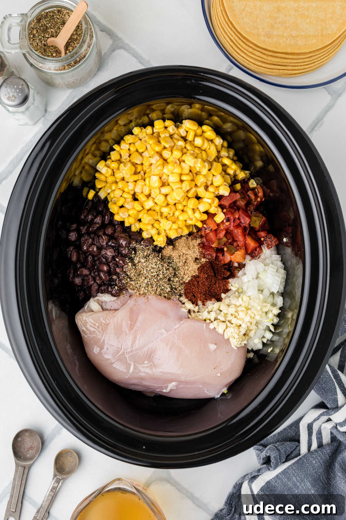A black crock pot filled with ingredients.