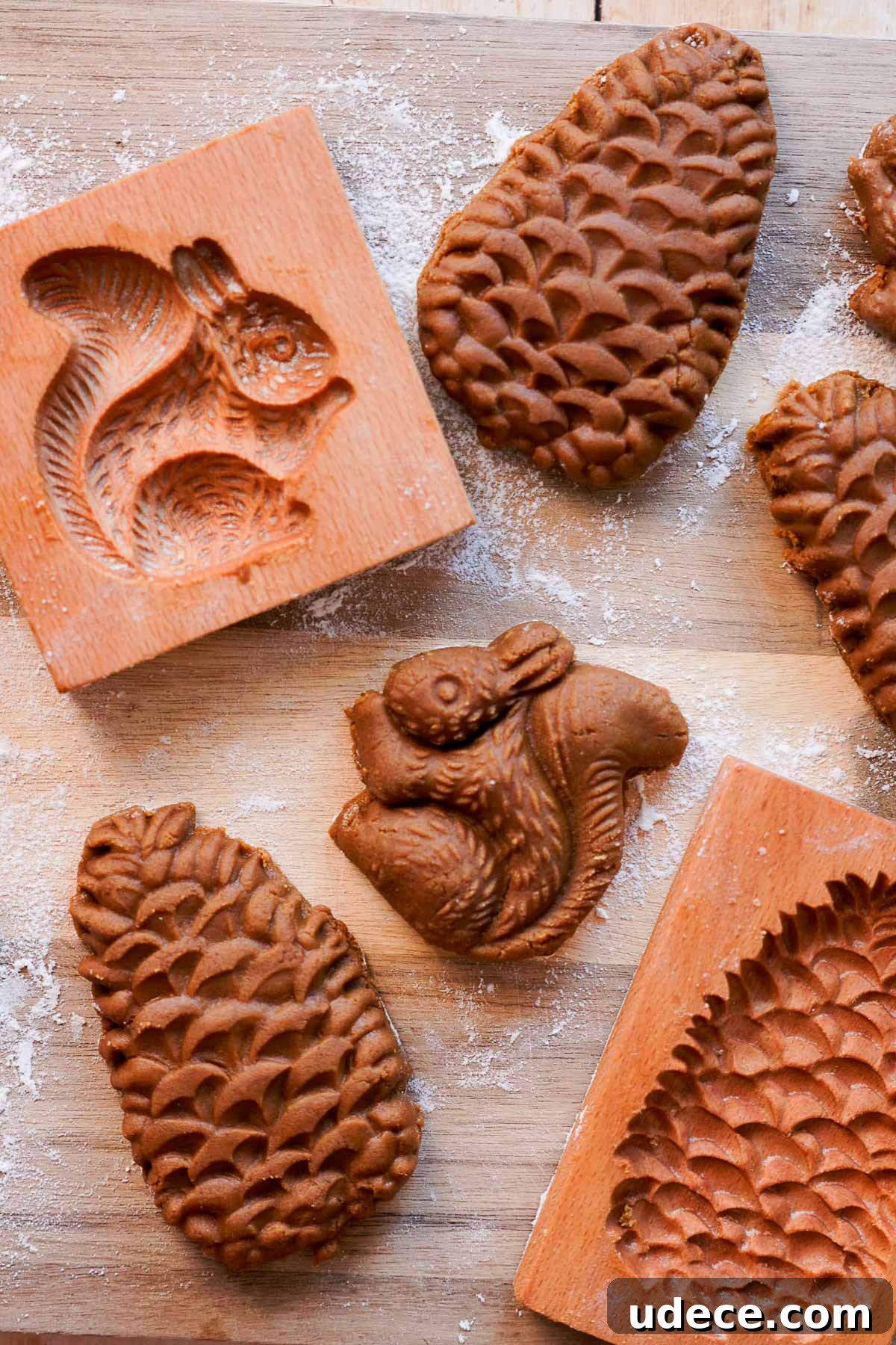 wooden cookie molds beside molded gingerbread cookies