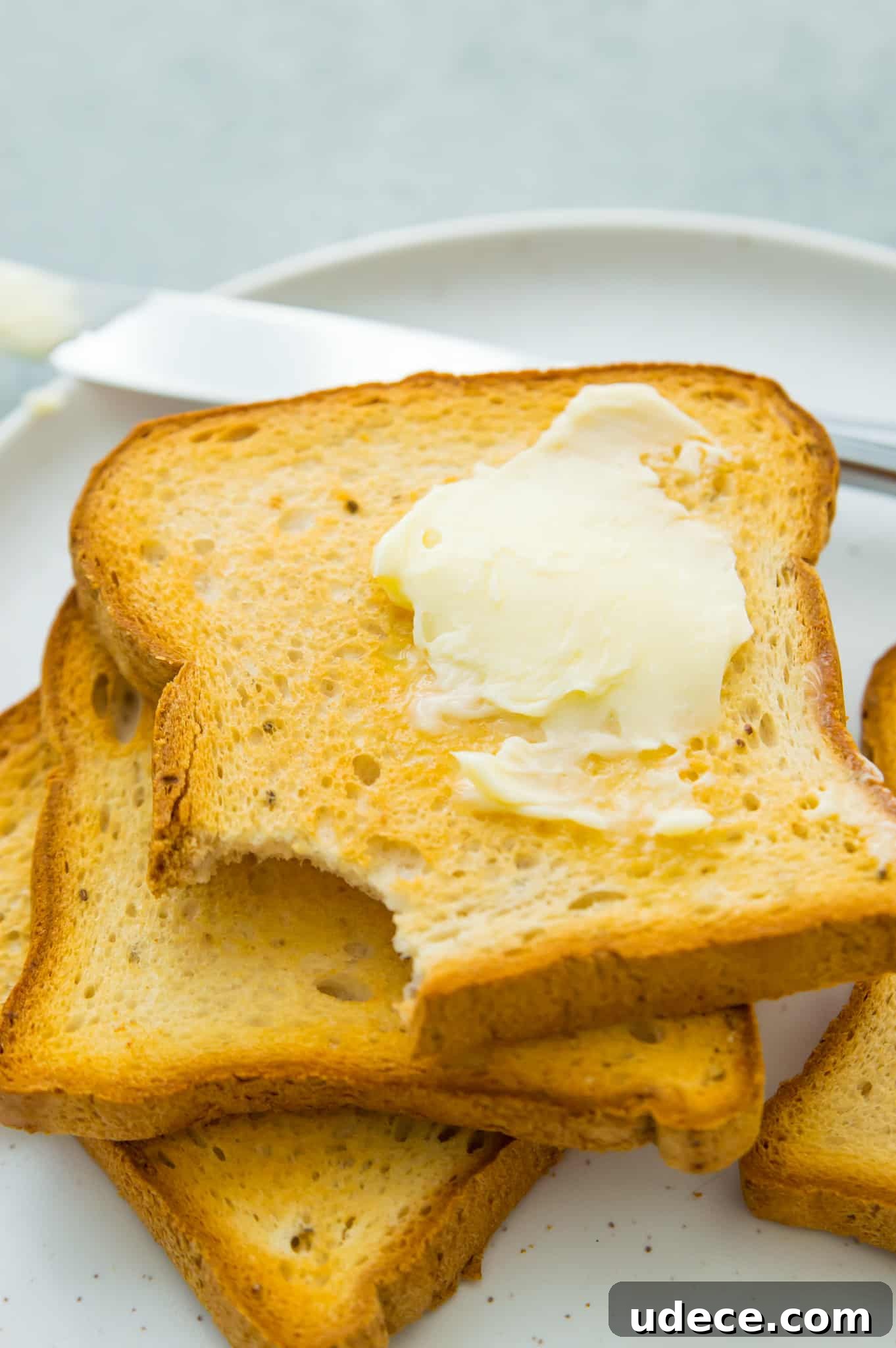A stack of air fryer toast with melted butter on top.