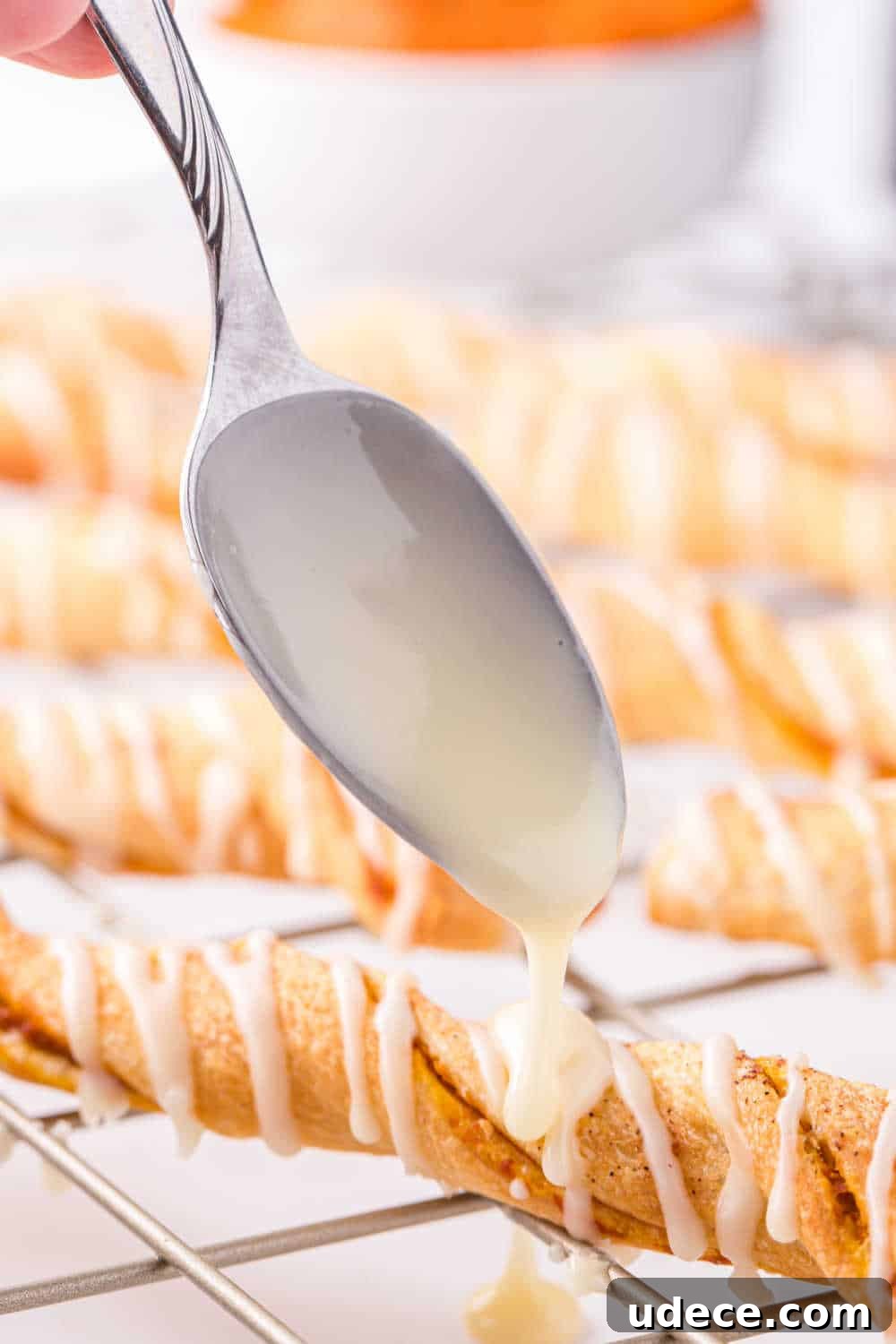 A spoon drizzling glaze on the recipe.