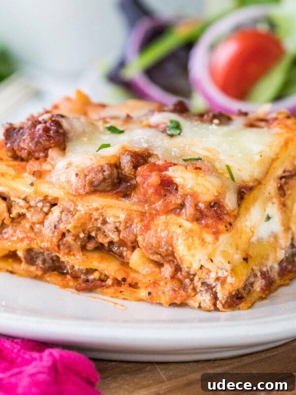 Closeup of finished lasagna showing the layers on a white plate