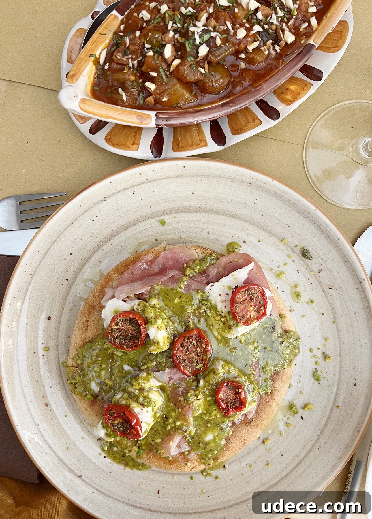 Focaccia topped with mortadella, cheese, and pistachio pesto