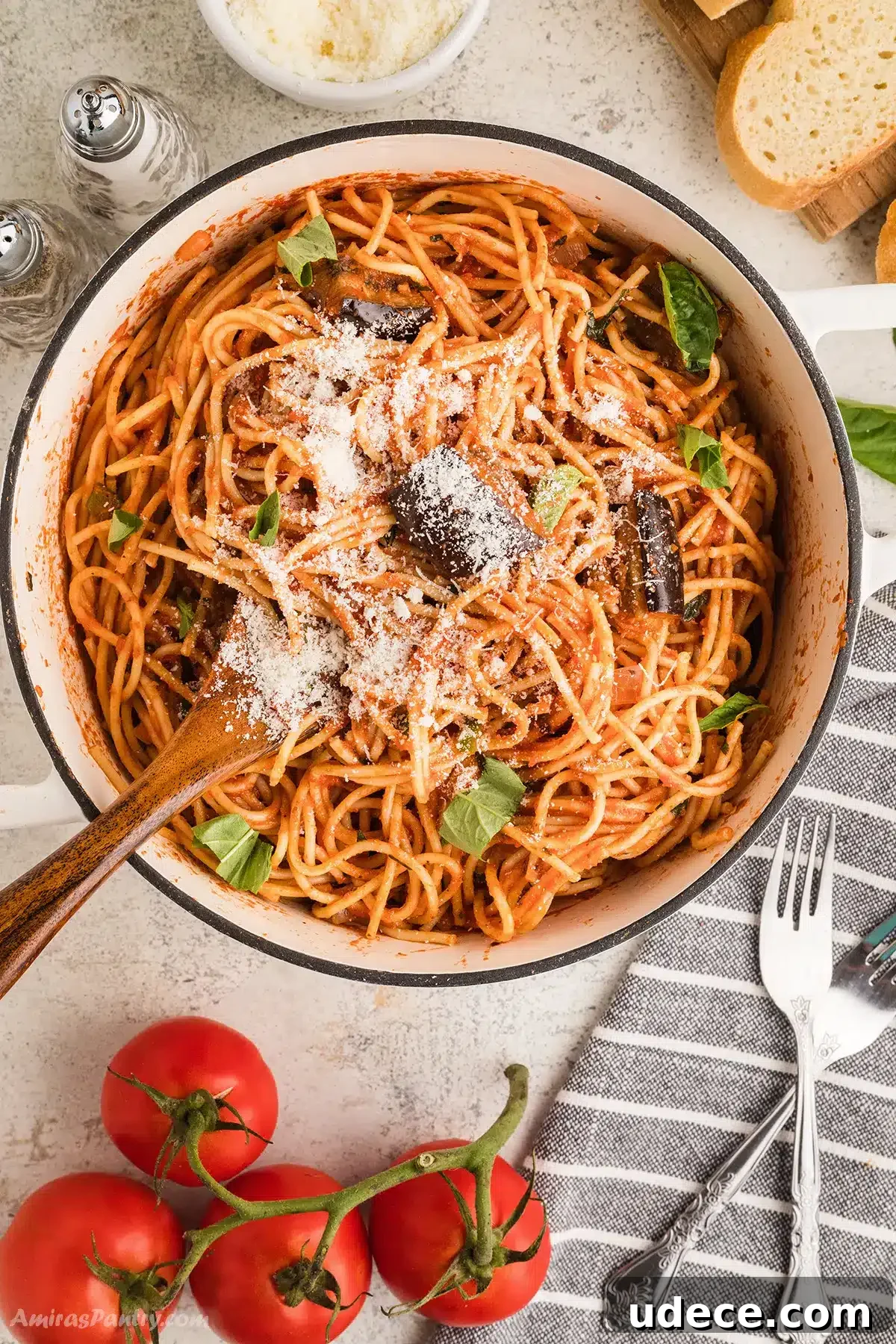 An overhead image of a big pot of pasta with eggplant.