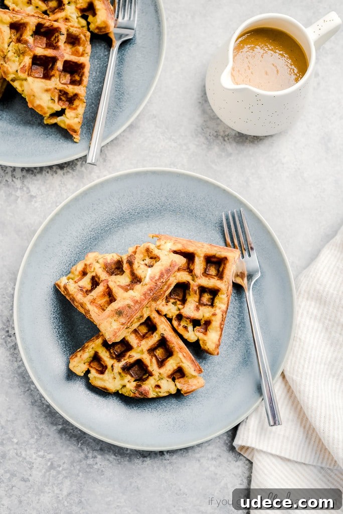 three waffle triangles on blue plate with fork; small pitcher of gravy next to plate