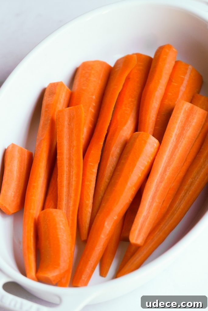 peeled and trimmed carrots in a baking dish
